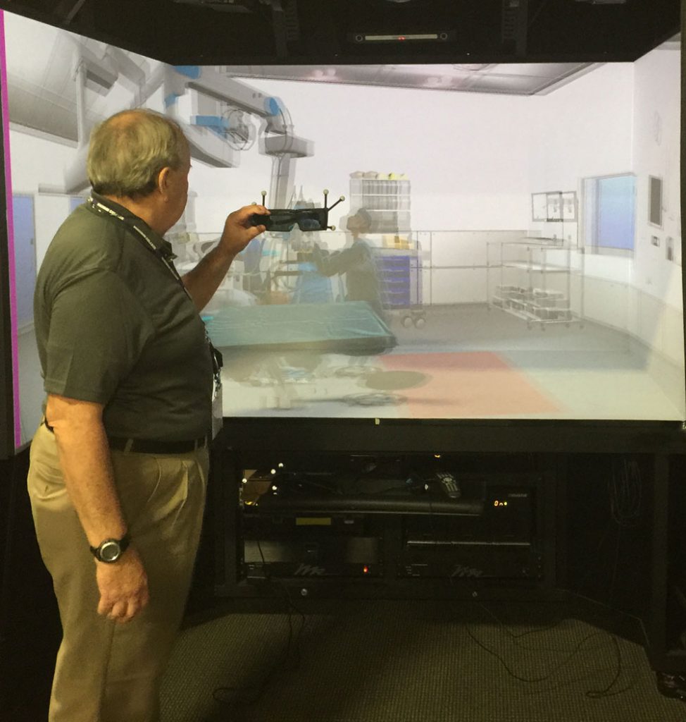 Rave Cave President Art Adlam prepares for virtual surgery in front of a more portable, but less immersive VR CAVE.